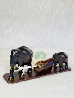 Elephant carrying log